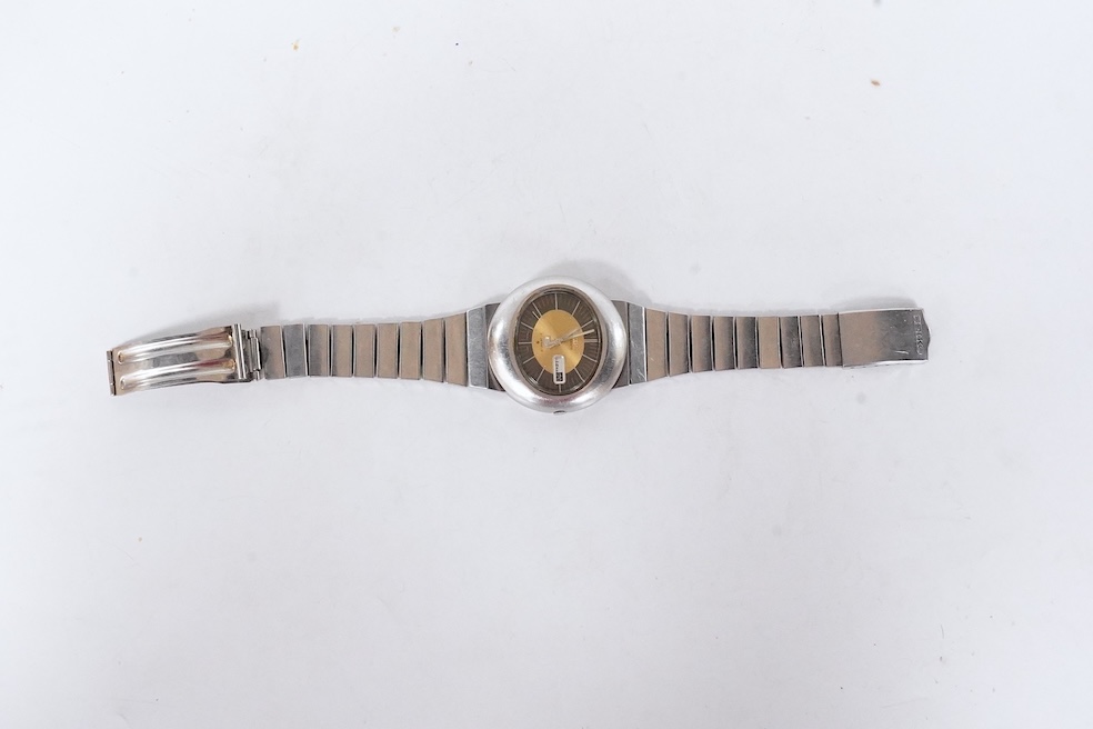 A gentleman's steel Seiko 5 Automatic wrist watch, with oval dial, baton numerals and date aperture, case diameter 40mm, case back numbered 228258, on a stainless steel Seiko bracelet(a.f.), no box or papers. Condition -